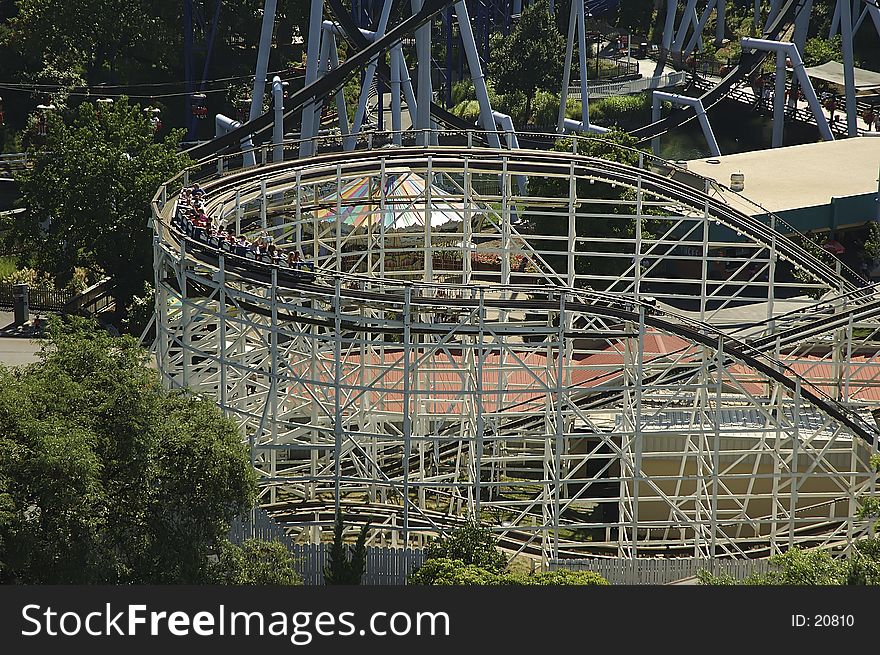 Photo of Rollercoaster With Cars Ready To Make The Drop. Photo of Rollercoaster With Cars Ready To Make The Drop.