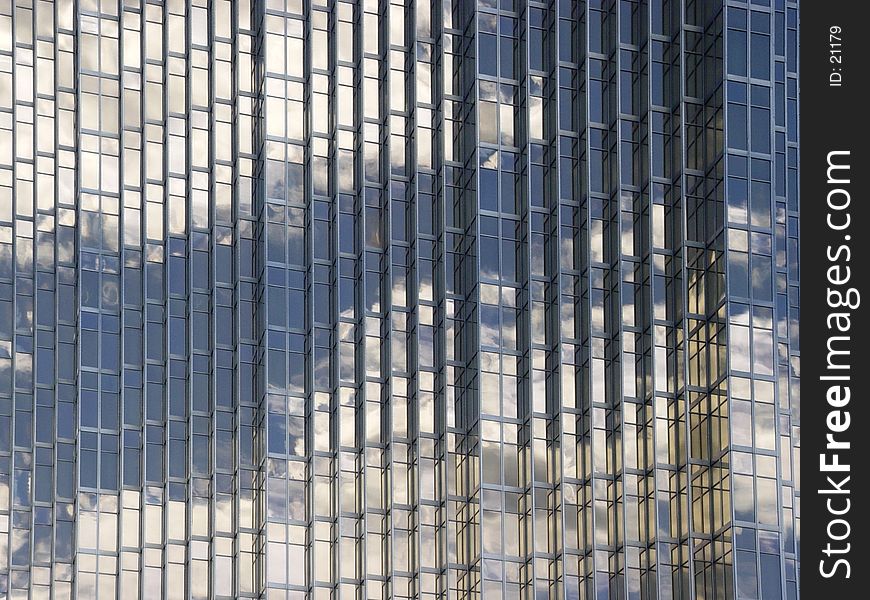 Blue sky and clouds reflected in the glass building in downtown Toronto. Blue sky and clouds reflected in the glass building in downtown Toronto