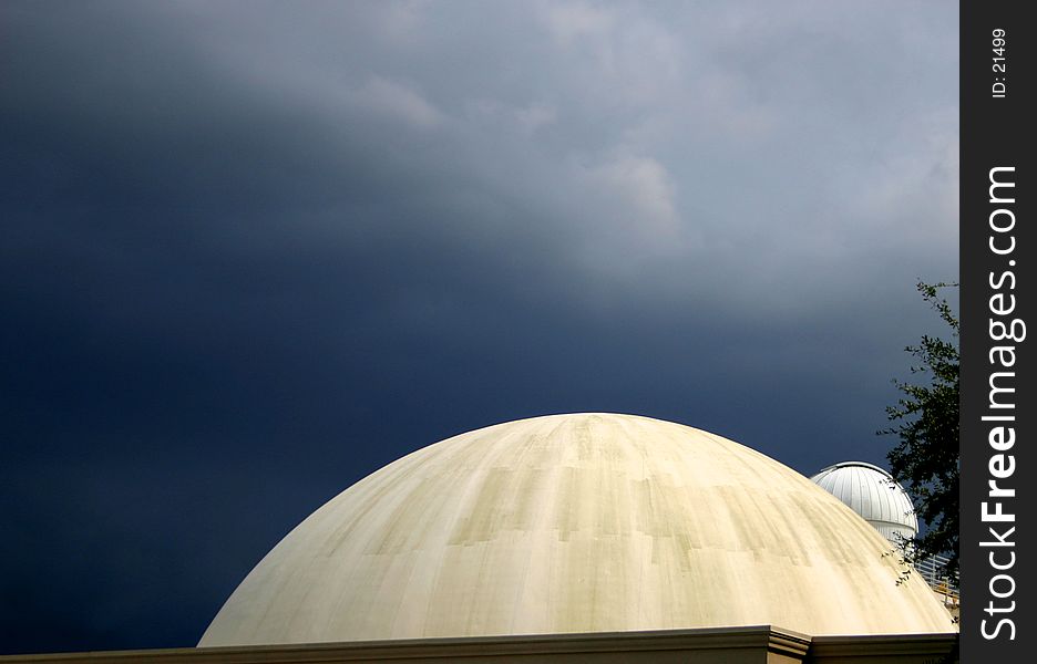 Dramatic effect of planetarium with dark storm approaching in background