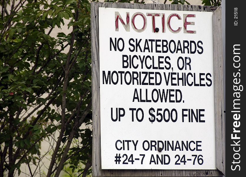 Sign which states no skateboards, bicycles or motorized vehicles. Sign which states no skateboards, bicycles or motorized vehicles