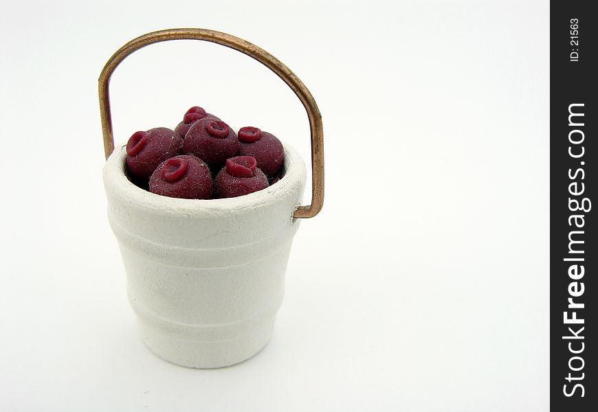 Fake Berries in a white bucket, isolated on white background. Fake Berries in a white bucket, isolated on white background