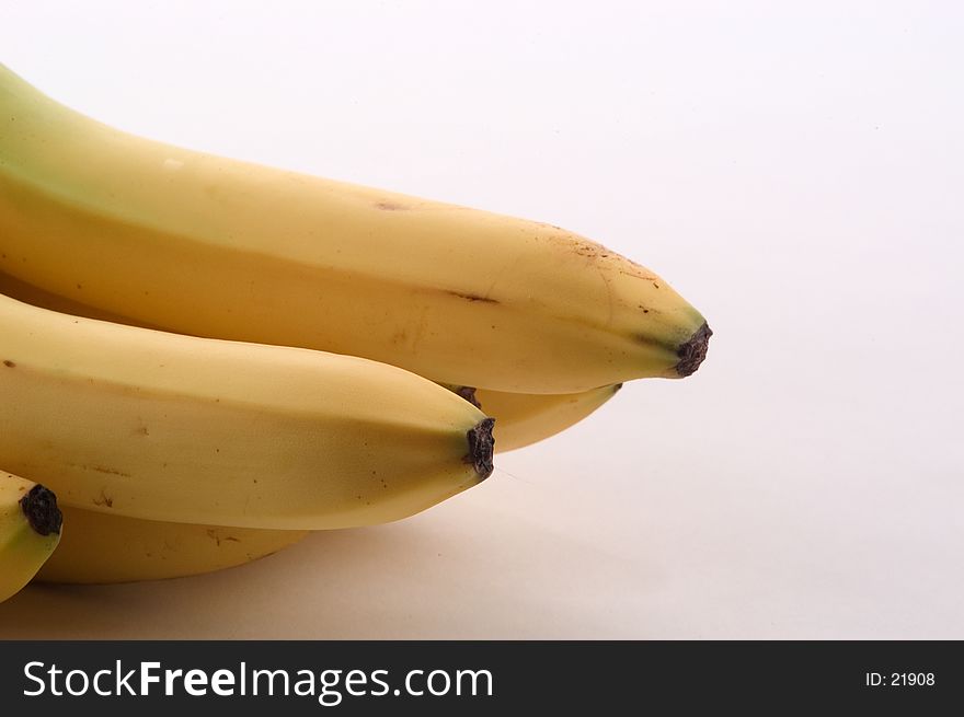Banana ends photographed entering the image from the left edge. Photographed on a white background