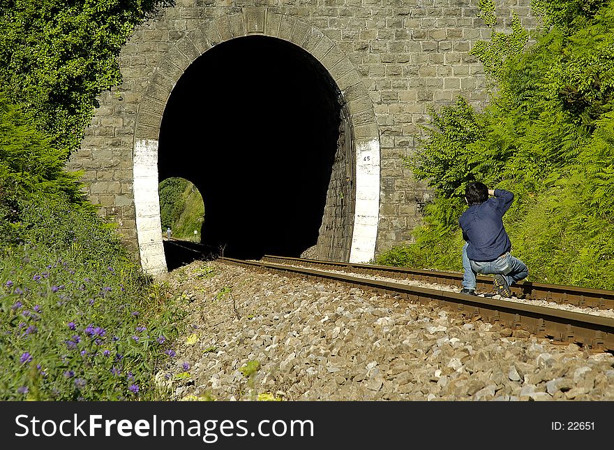 While a villager walking at end of tunnel, photographer trying to frame her. While a villager walking at end of tunnel, photographer trying to frame her.