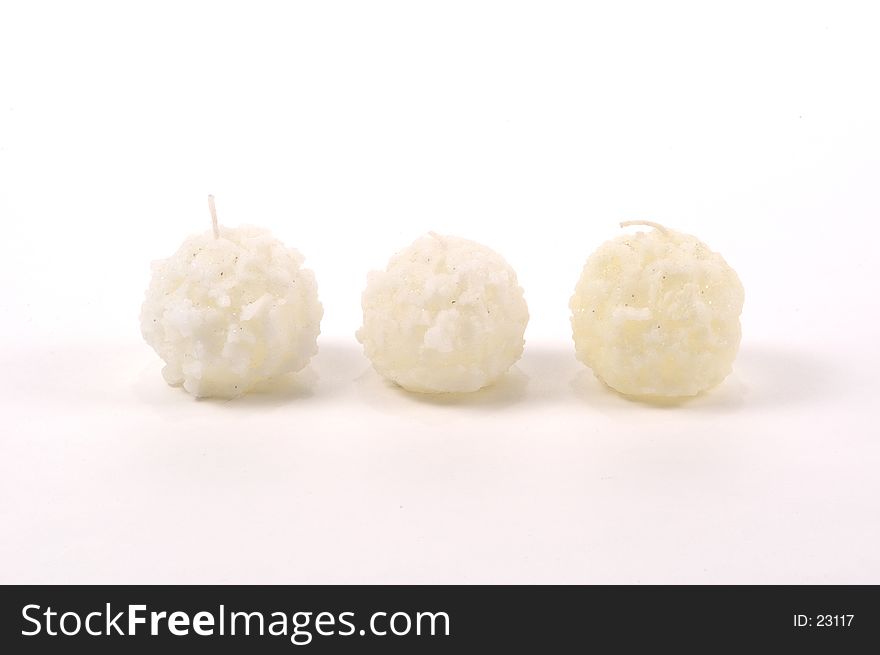 3 candles in the shape of small snowballs with glitter embedded. 3 candles in the shape of small snowballs with glitter embedded.