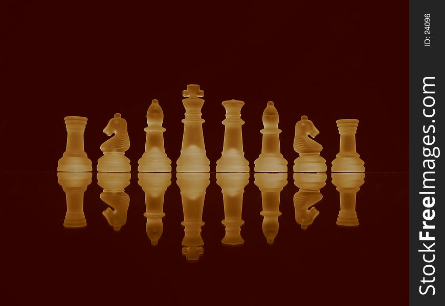 Chessmen in a row in sepia tone. Chessmen in a row in sepia tone.