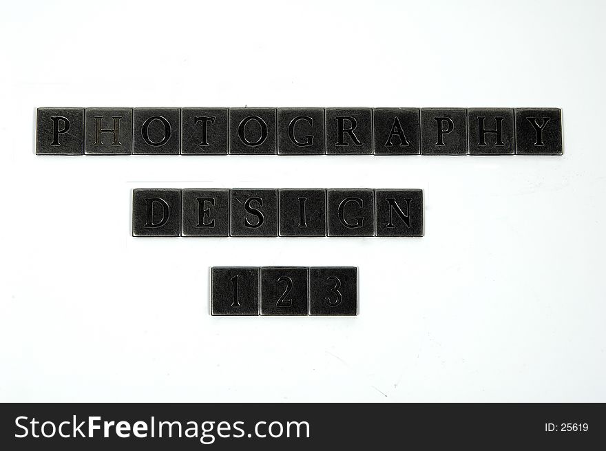 Photo of Square Metal Pieces With Letters Engraved in Them. The Words Photography and Design Are Spelled Out as Well as The Numbers 123. Individual Letters and Numbers Available on Request.