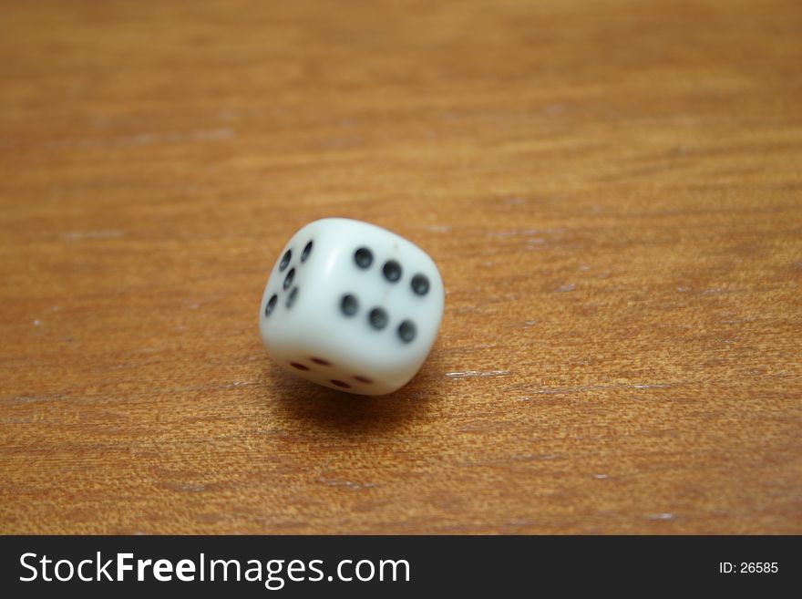 A spinning dice frozen by flash, slight motion blurring