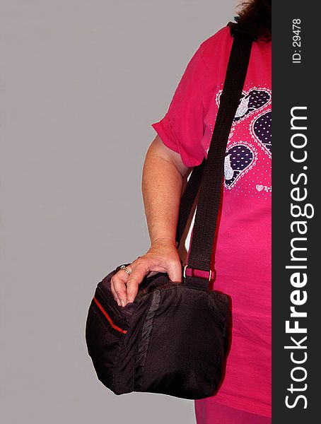 A lady carrying a camera tote bag. A lady carrying a camera tote bag