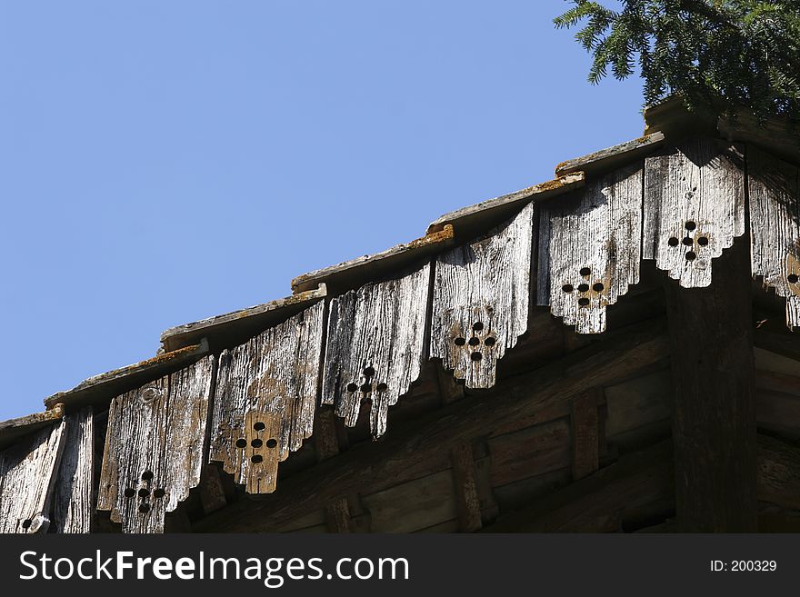 An old roof under a blue sky. An old roof under a blue sky