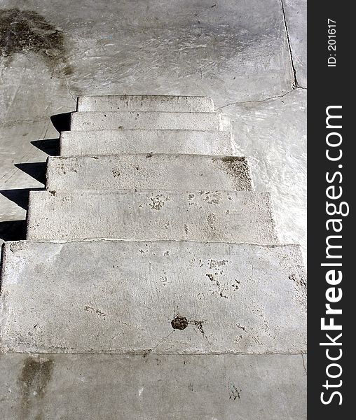 Looking down some concrete steps at a skate park. Has a gritty, urban texture. Looking down some concrete steps at a skate park. Has a gritty, urban texture.