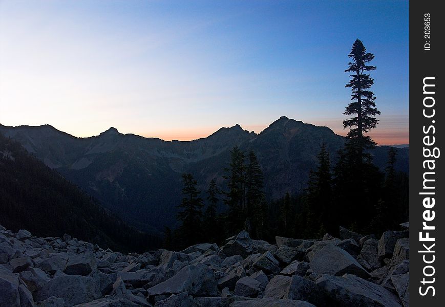 A sunrise view of Alaska Mountain and adjoining ridgeline as seen from the Pacific Crest Trail in Washington State. A sunrise view of Alaska Mountain and adjoining ridgeline as seen from the Pacific Crest Trail in Washington State.