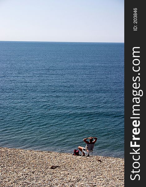 Man at the beach, fishing & relaxing. Man at the beach, fishing & relaxing