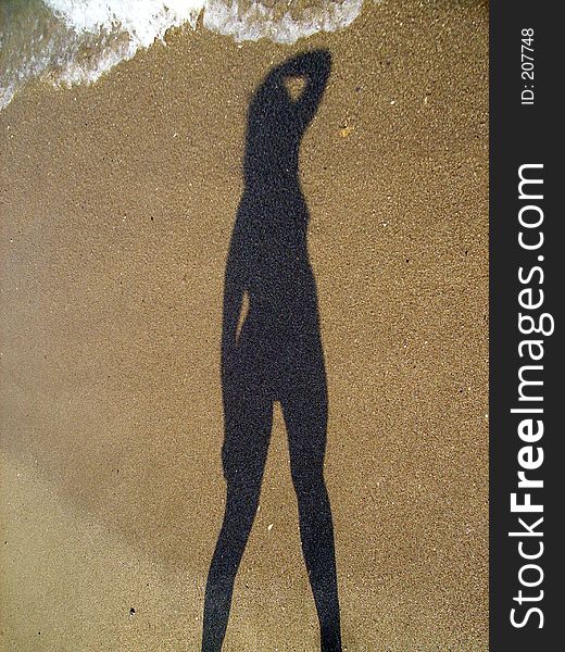 Girl shadow on the beach