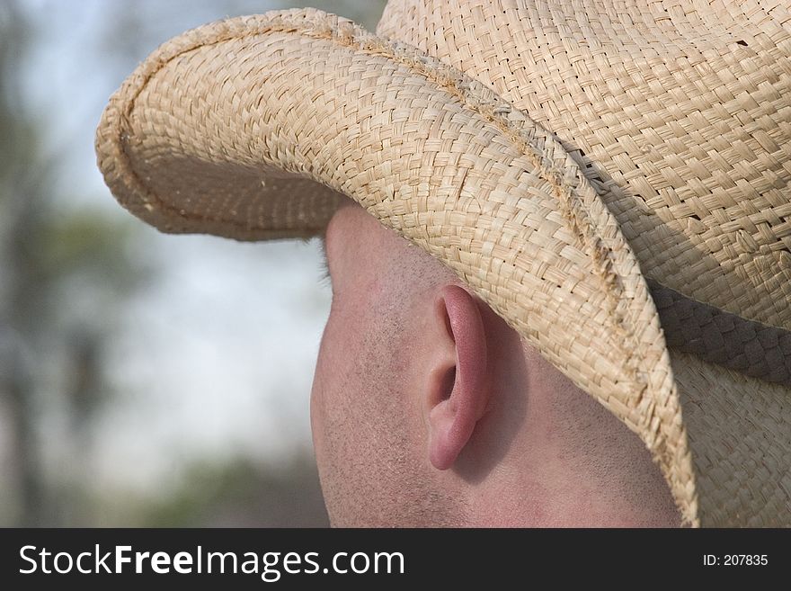 Man in straw hat looking into the distance. Man in straw hat looking into the distance