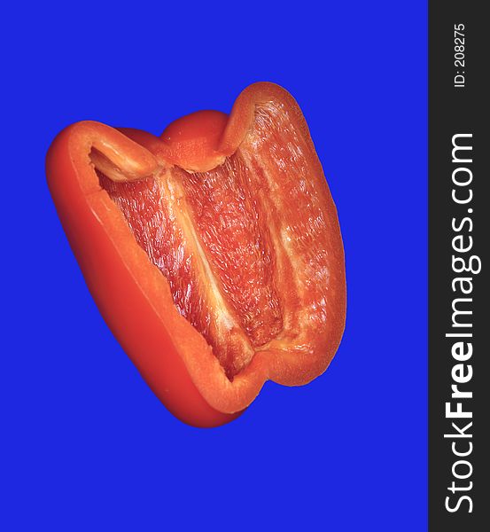 A sliced pepper on a blue background