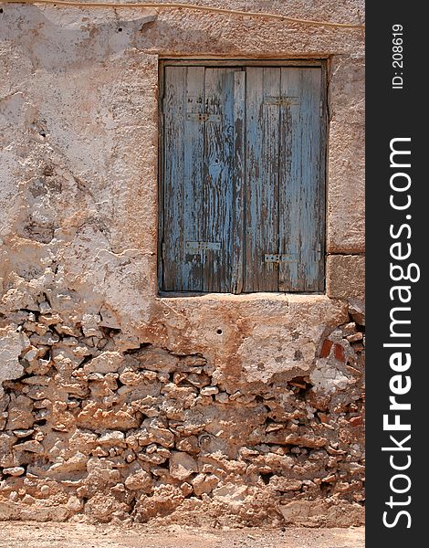 Blue window at deserted house