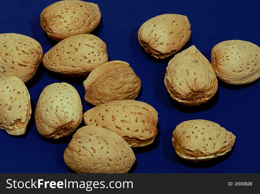 Collection of almonds on blue surface