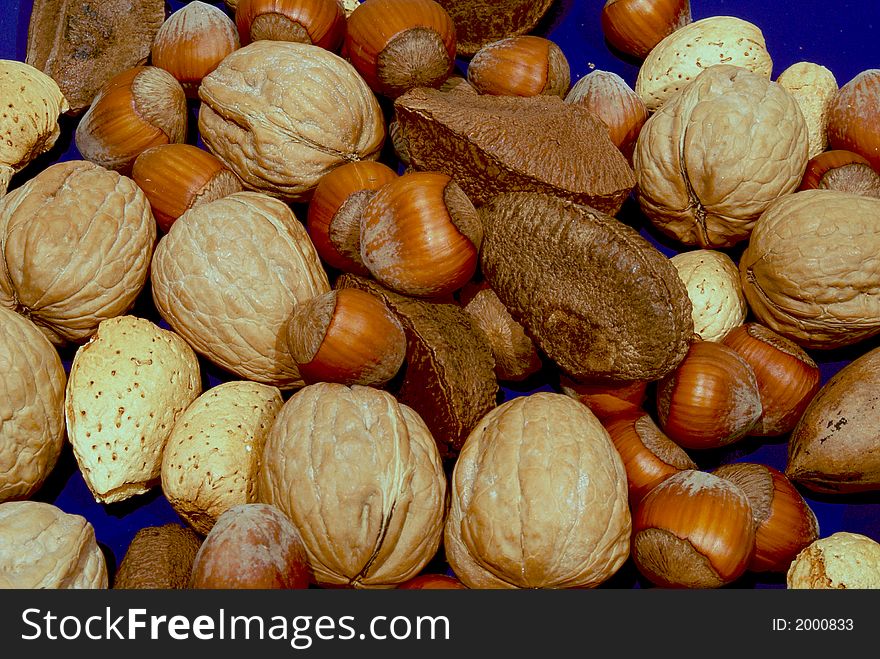 Mixed nuts on blue surface. Mixed nuts on blue surface