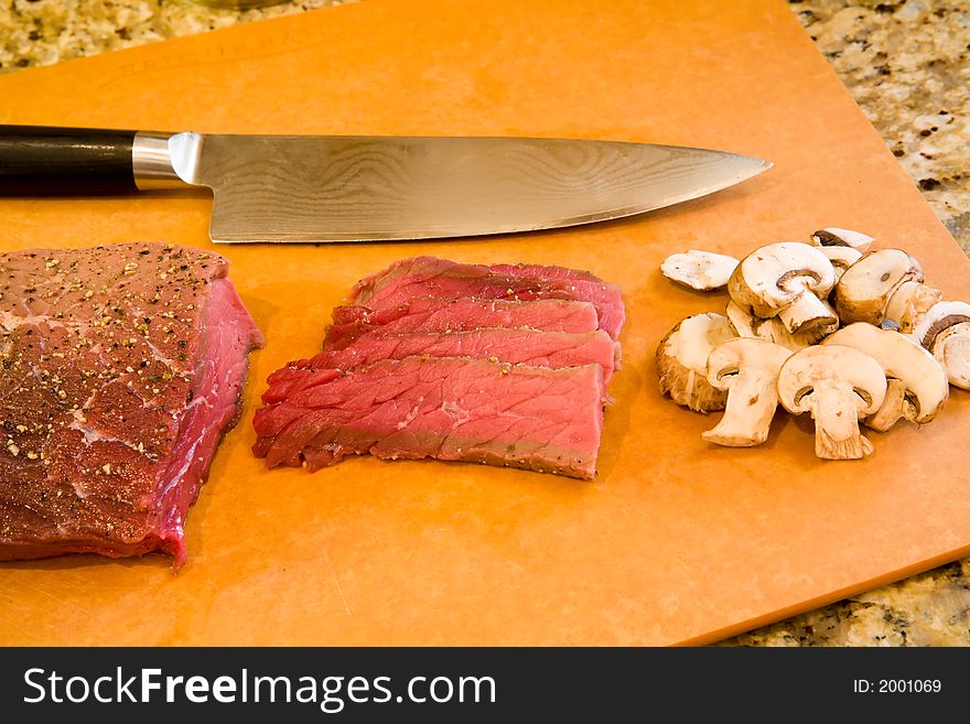 London broil seasoned and sliced with mushrooms ready to cook. London broil seasoned and sliced with mushrooms ready to cook