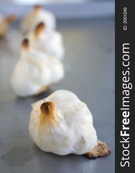 Bulbs of Roasted Garlic on a roasting pan fresh out of the oven. A healthy start to any recipe. Bulbs of Roasted Garlic on a roasting pan fresh out of the oven. A healthy start to any recipe.