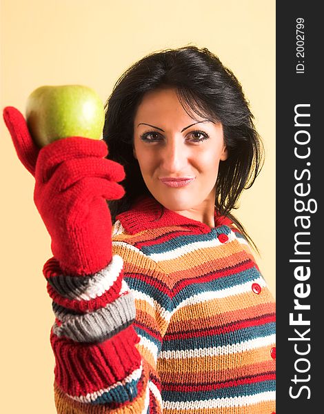 Young brunette woman with a green apple