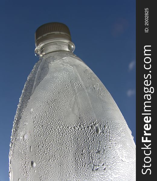 Water drops in a bottle and blue sky