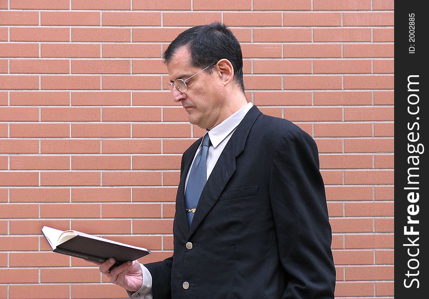 Outstanding businessman with briefcase and coat