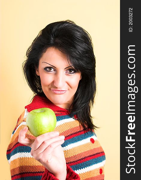 Young brunette woman with a green apple