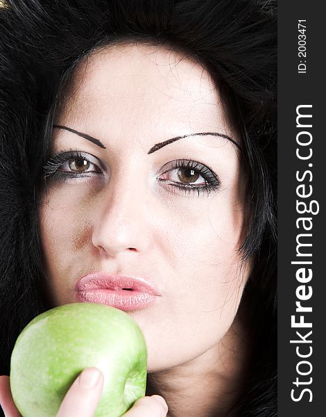 Brunette woman with winter coat and holding a green apple. Brunette woman with winter coat and holding a green apple