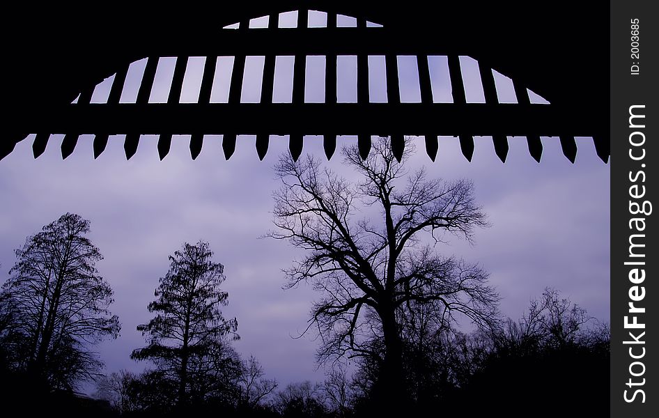 Silhouette of medieval open gate, with trees at the background. Silhouette of medieval open gate, with trees at the background.