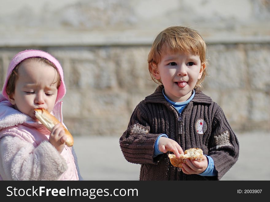 Two nice children outdoor eating. Two nice children outdoor eating