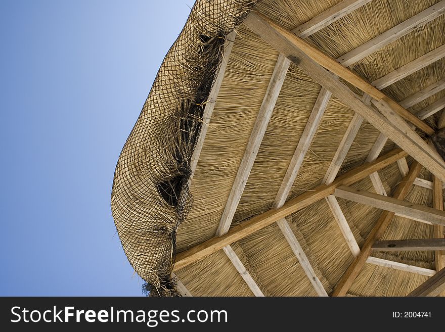 A beach hut covering made from straw. A beach hut covering made from straw
