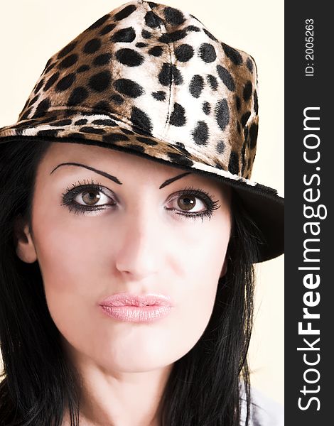 Beautiful brunette young woman with hat of leopard