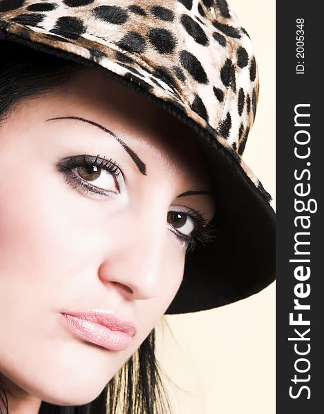 Beautiful brunette young woman with hat of leopard