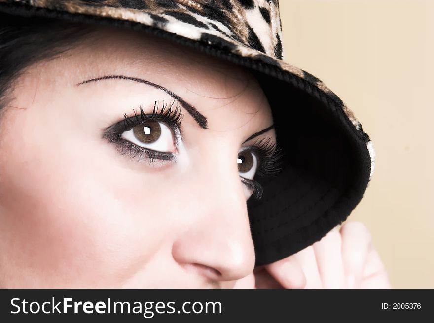 Beautiful brunette young woman with hat of leopard