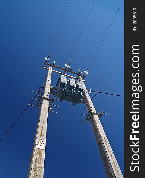 Solitary electricity pylon - against a blue sky