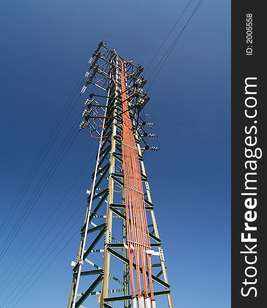 Solitary electricity pylon - against a blue sky