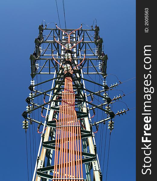 Solitary electricity pylon - against a blue sky