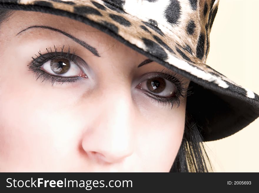 Beautiful brunette young woman with hat of leopard