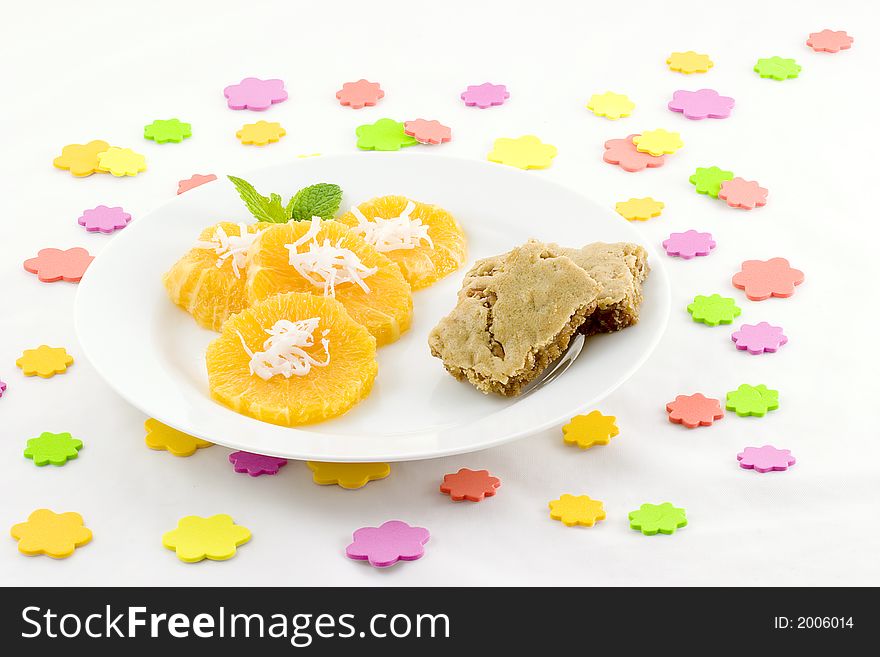 I scattered sponge dots over the table, then served orange slices topped with coconut and added  butterscotch brownies (Praline squares). I scattered sponge dots over the table, then served orange slices topped with coconut and added  butterscotch brownies (Praline squares).