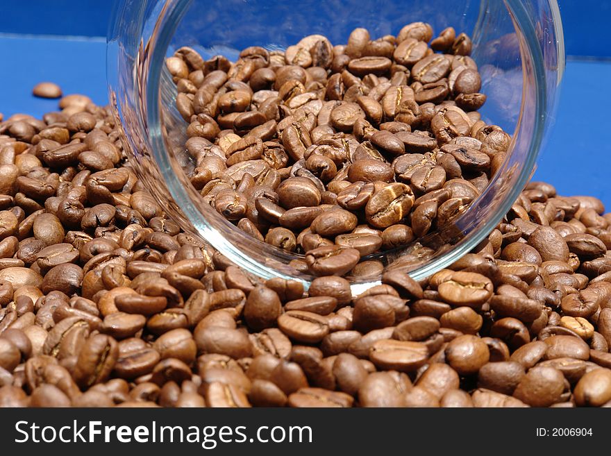 Coffee beans spilling from glass canister