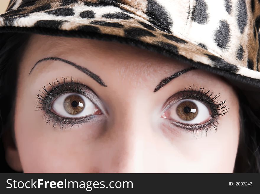 Beautiful brunette young woman with hat of leopard