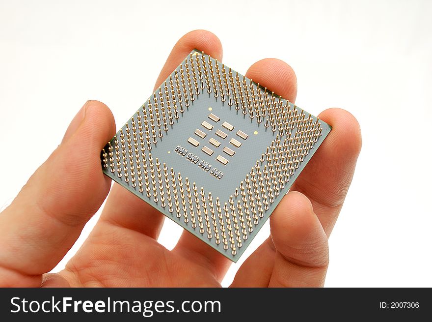 Hand holding a processor - view at it's pins. Hand holding a processor - view at it's pins