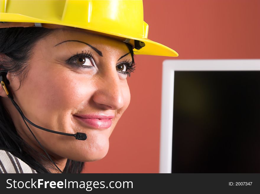 A businesswoman with headphone and helmet in office
