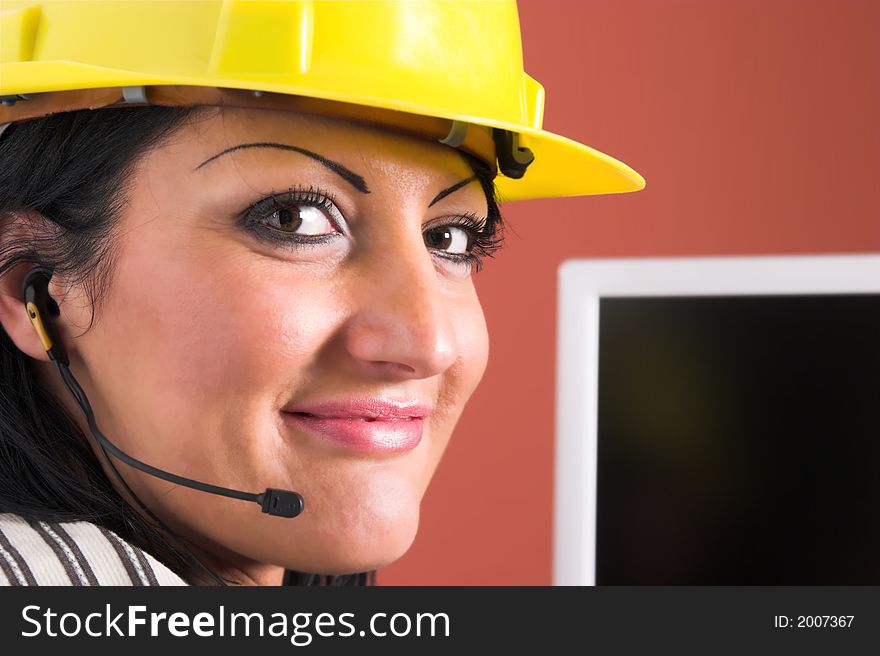 A businesswoman with headphone and helmet in office