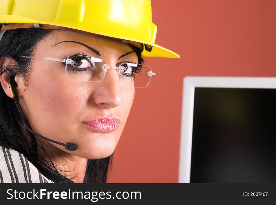 A businesswoman headphone and helmet in office