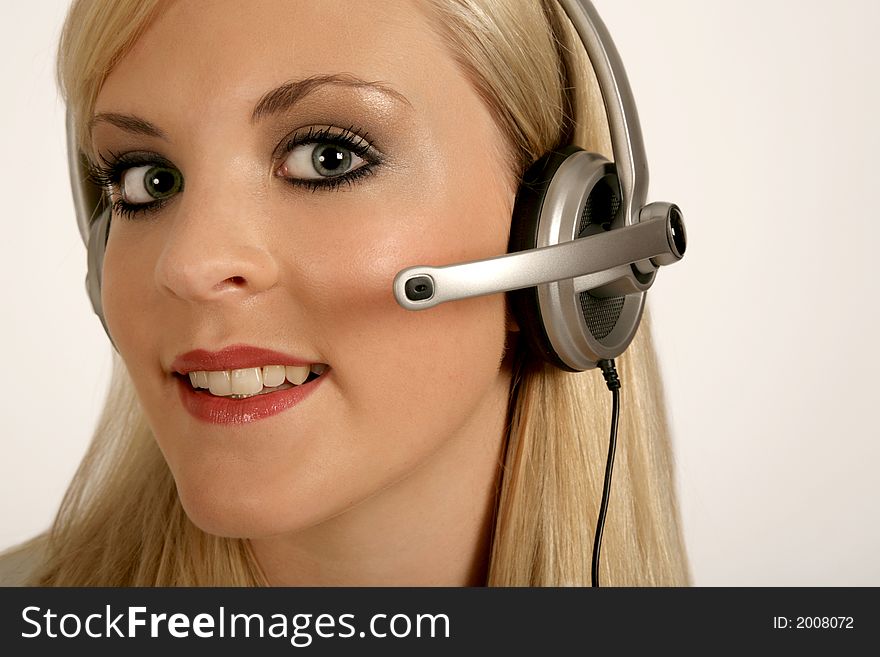 A Blond woman Communicating on a headpiece phone. A Blond woman Communicating on a headpiece phone