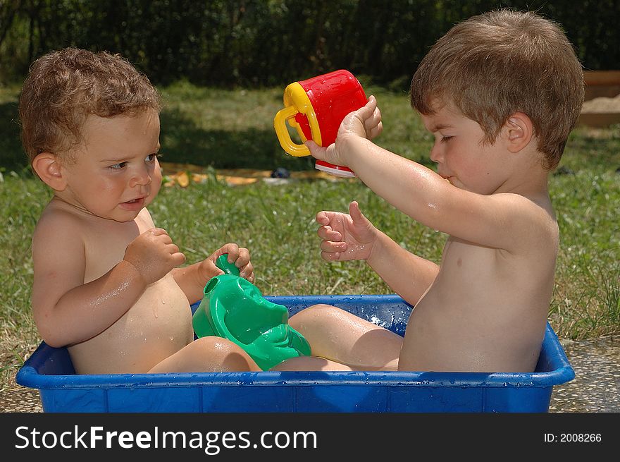 Two boys playing with water. Two boys playing with water