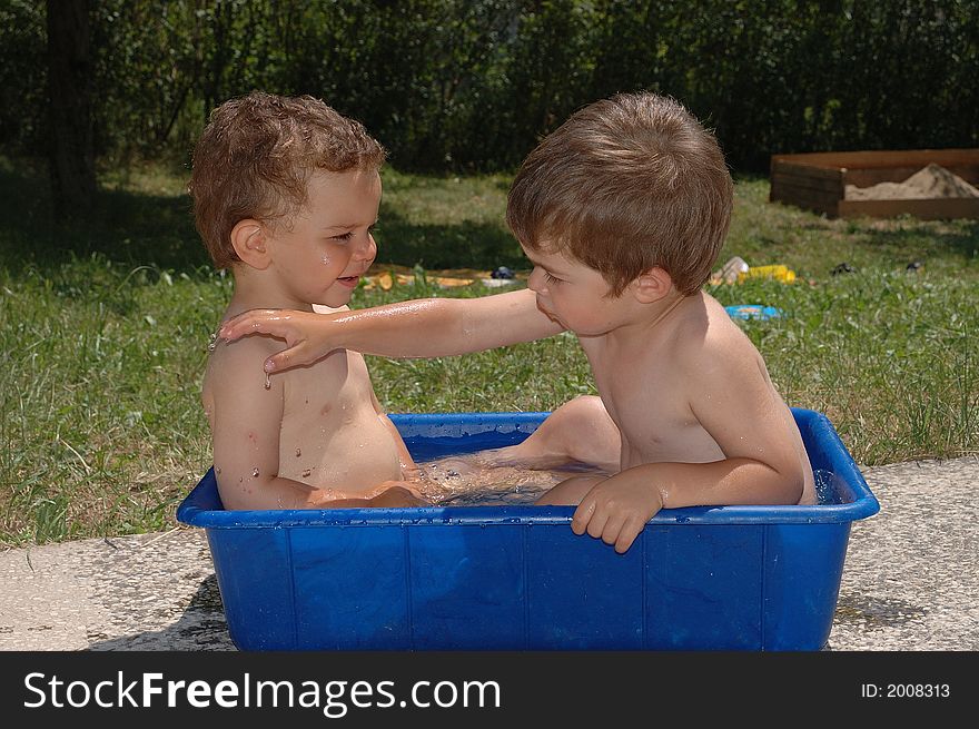 Two boys playing with water. Two boys playing with water