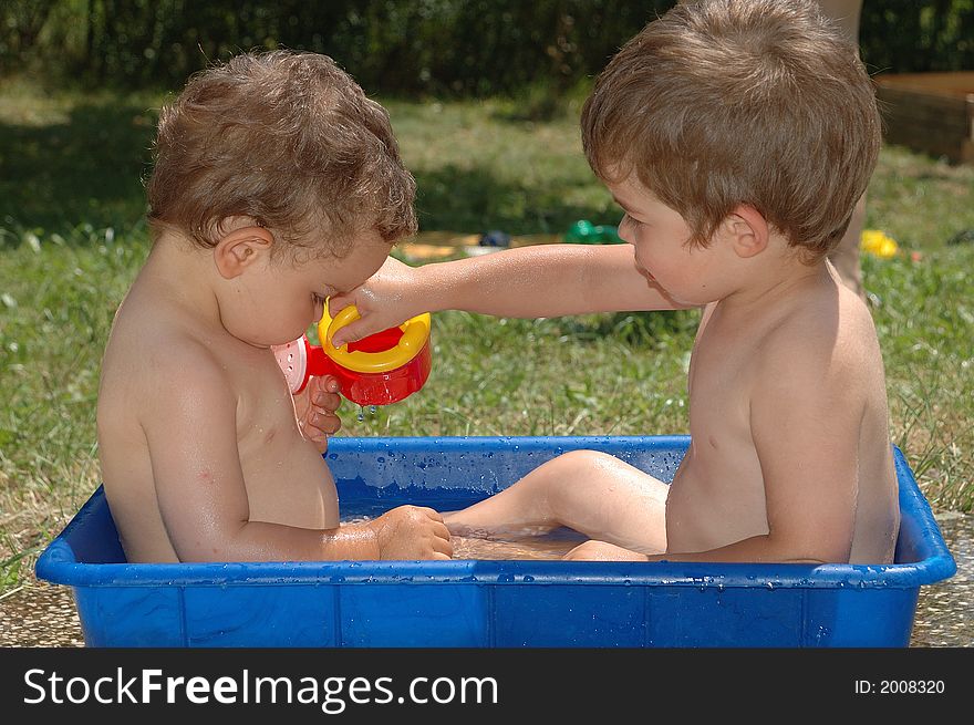 Two boys playing with water. Two boys playing with water